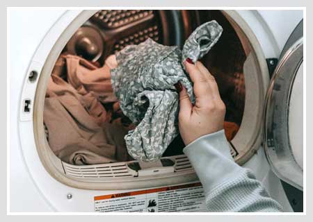 Putting Laundry into Washing Machine